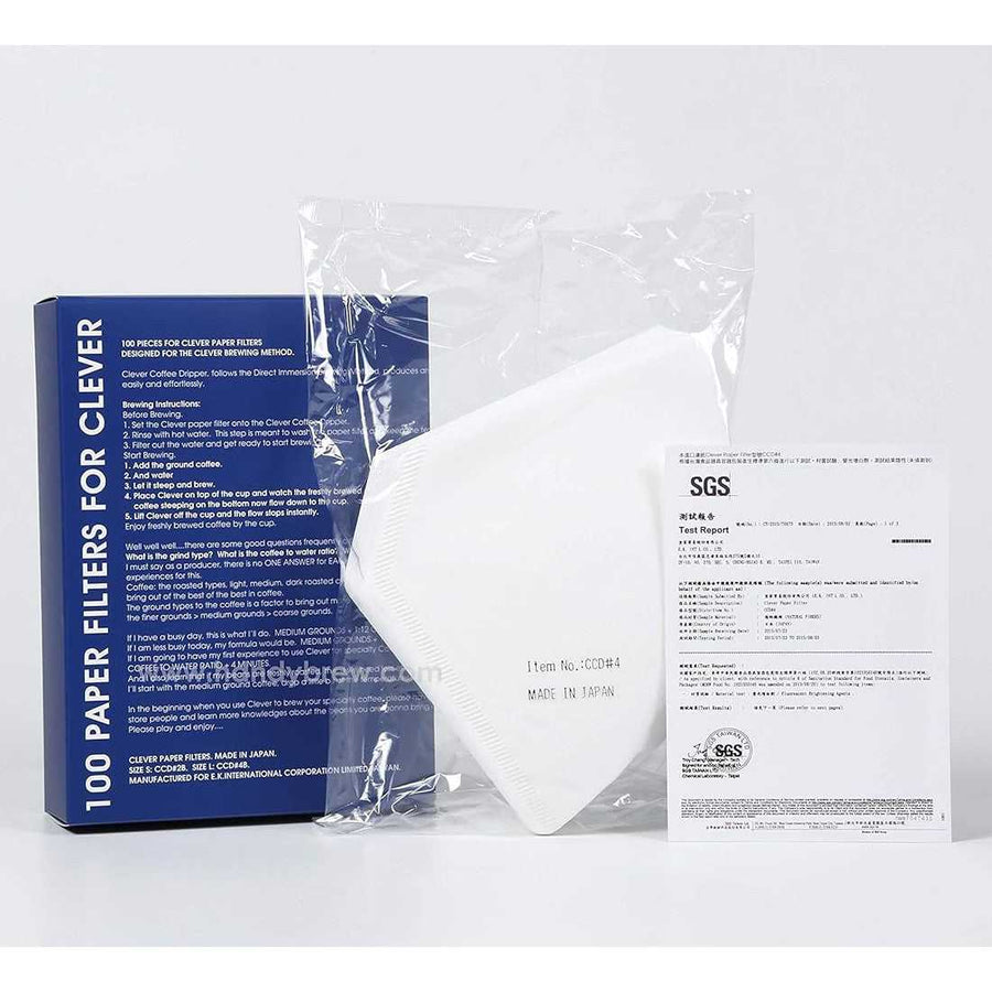 A sealed plastic bag containing white filter papers for the Clever Dripper, with a blue label on the bag and a separate white label attached to the bag providing product information.