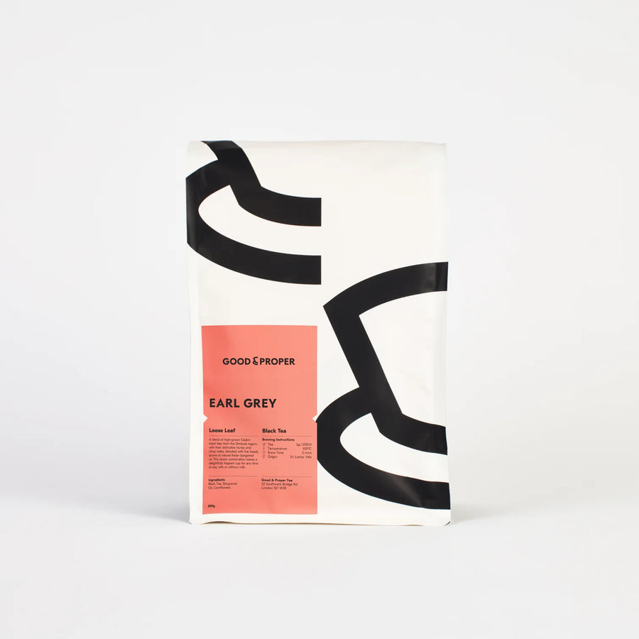 A packaged bag of Good & Proper Earl Grey loose leaf tea with a minimalist design, featuring white, pink and black colours.