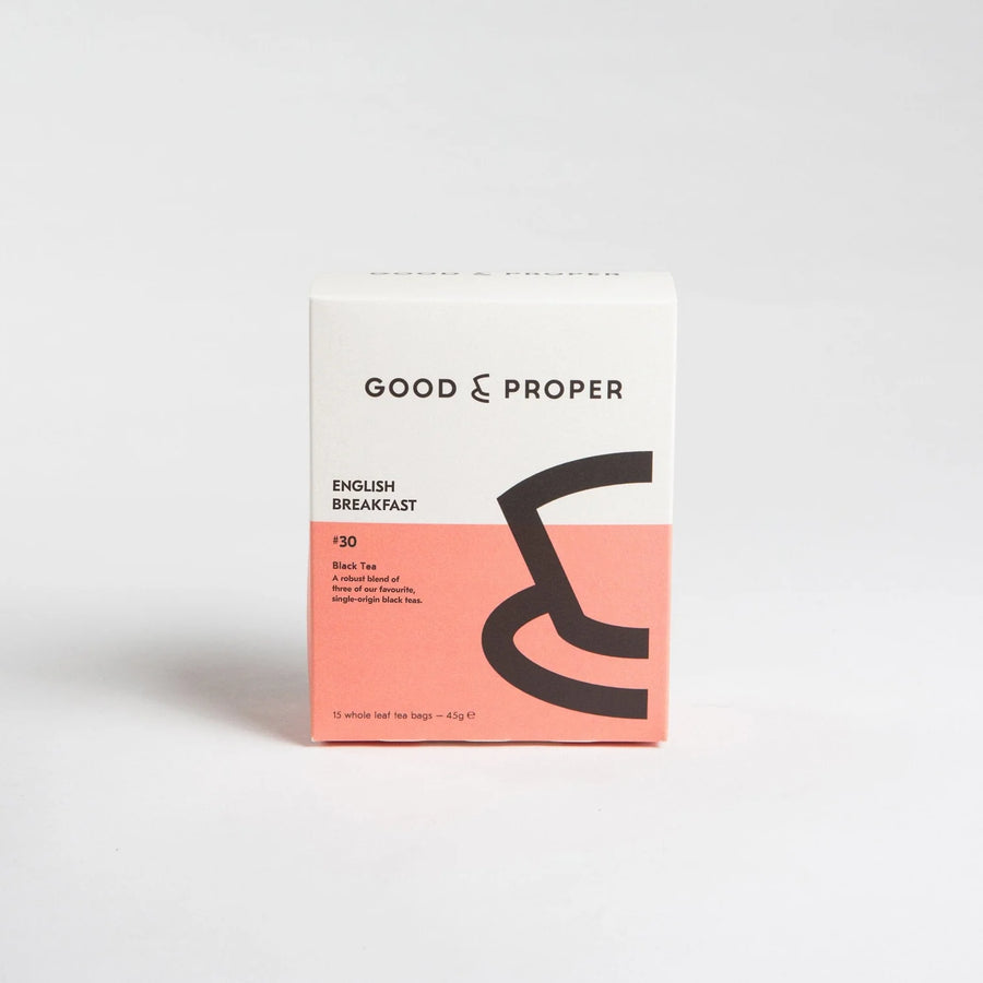 A cardboard box packaging of Good & Proper English Breakfast tea with a pink and black color scheme.