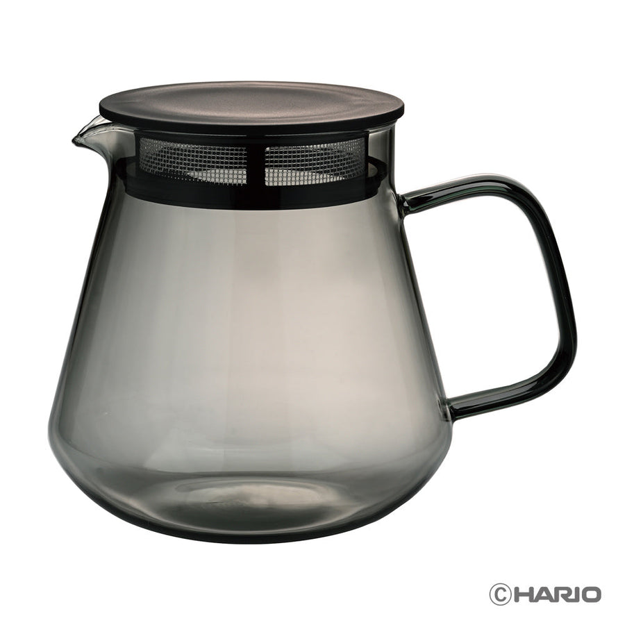 Smoky gray glass coffee server with black handle and lid on a white background, featuring the Hario logo.
