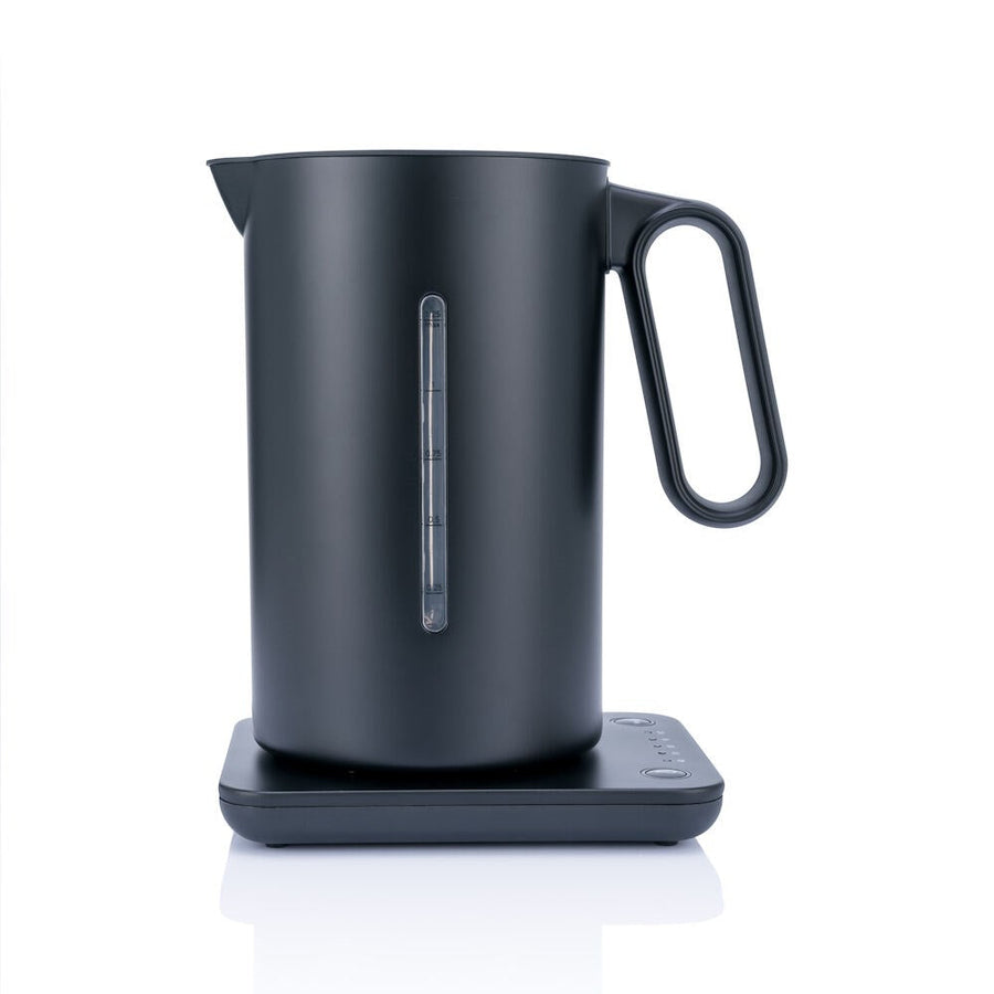 A black Wilfa fixed temperature control kettle on a stand, with a digital temperature readout on the front.