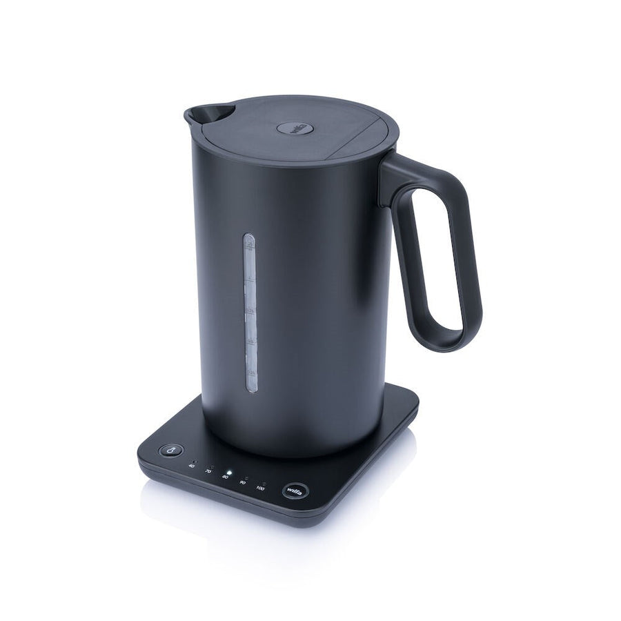 A black Wilfa fixed temperature control kettle on a stand, with a digital temperature readout on the front.
