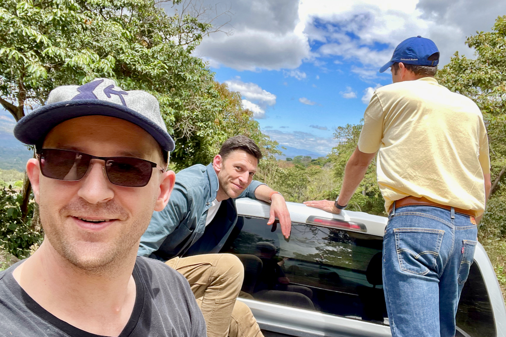 Ozone Green Buyer Roland Glew, 2017 World Barista Champion Dale Harris, and Alejandro Martinez ride together in the back of a pickup truck at Finca Argentina in El Salvador.