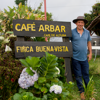 Carlos Arietta beside the sign next to the Arbar mill