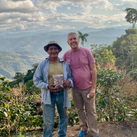 Pedro Flores and Pedro Pablo Rodriguez with a sample of Pedro's coffee, stood on Pedro's farm Villa Rosario, in Caranavi, Bolivia