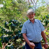 Mauricio Martinez by some of his coffee plants at Finca Argentina in El Salvador