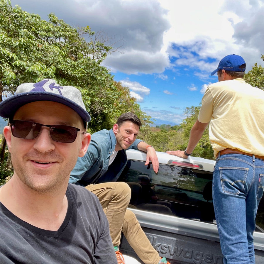 Ozone Green Buyer Roland Glew, 2017 World Barista Champion Dale Harris, and Alejandro Martinez riding in the back of a pickup truck in Ahuachapán, El Salvador