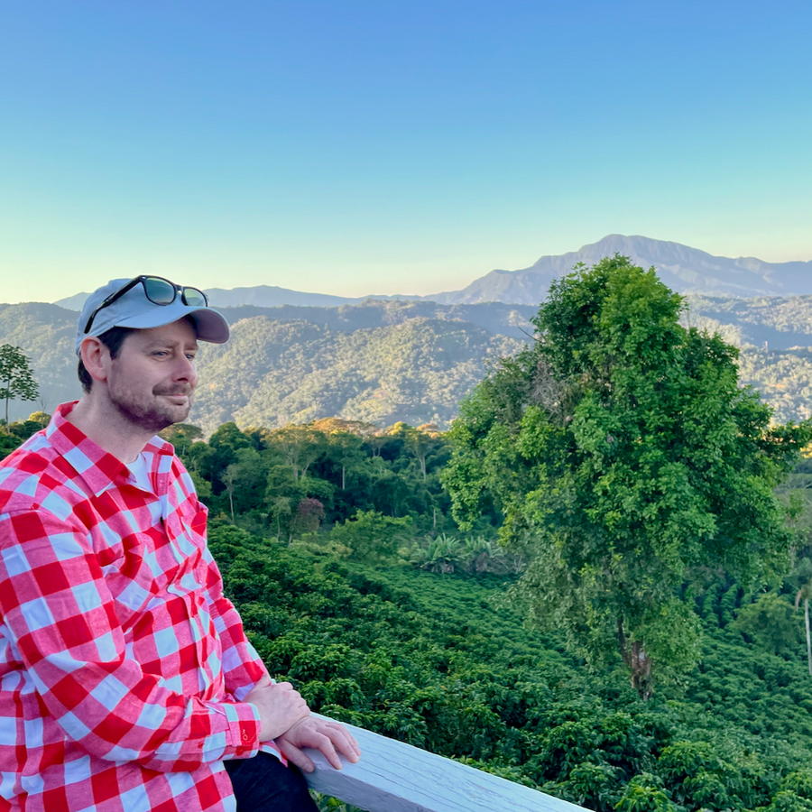 Ozone Head Roaster Gary Whiteley at Las Alasitas in Yungas, Bolivia, with coffee growing in the background