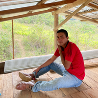 Einer Saldivar sat inside one of his new farm buildings at El Cedro in Cajamarca, Peru