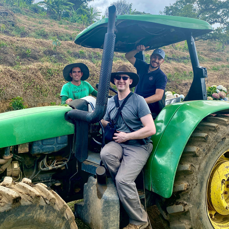 Allan Oviedo, OCR Green Buyer Roland Glew and Davian Campos from Exclusive Coffees after a tractor ride to the Don Joel micromill