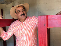 Guadalupe 'Beto' Reyes amongst coffee drying beds at El Limon in Palencia, Guatemala