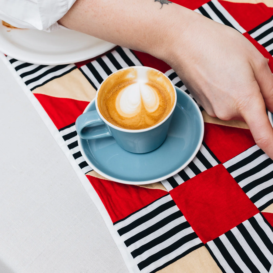 Acme Roman Cup Small Kokako (Blue) 150ml and saucer with a coffee