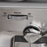 Close-up of Sage Barista Express™ Impress SES876 Home Espresso Machine's grind size adjustment dial with labels.