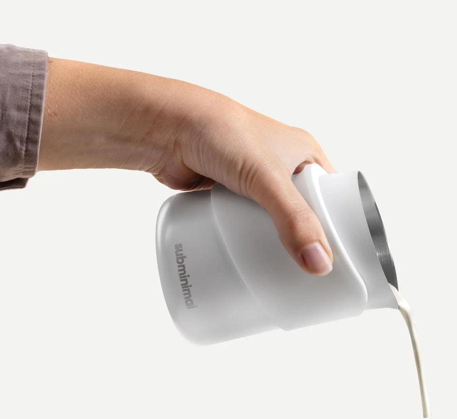 Subliminal Handleless FlowTip Jug - White pouring milk from a hand FT-03-WH-HL