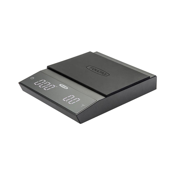 A black Felicita Incline Coffee Scale with an LCD display, measuring weight and time, placed on a flat surface.