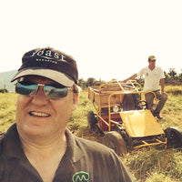 Stephen Hurst, owner of Fazenda Inglaterra, with a worker on a dune buggy at Fazenda Inglaterra