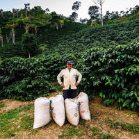 Gregorio Palli Mamani with sacks of coffee at Volcán del Tigre, Copacabana, Bolivia